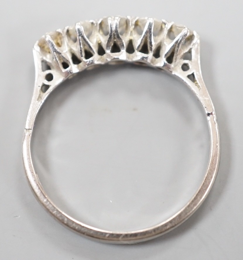 A plat and 18ct five stone diamond set half hoop ring, size K, gross weight 2 grams.